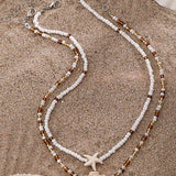 Náhrdelník s mušlí a hvězdicí